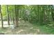 Wooded backyard path with a white bench at 2477 Briar Valley Way, Dacula, GA 30019