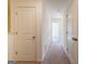 Hallway with carpeted floor and doors to bedrooms and bathrooms at 177 Swindon Dr, Mcdonough, GA 30253