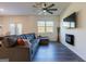 Spacious living room with L-shaped sectional sofa and electric fireplace at 177 Swindon Dr, Mcdonough, GA 30253
