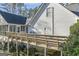 Picture of a raised, wooden back deck overlooking a yard with dense natural wooded area at 730 N Bethany Rd, Mcdonough, GA 30252