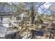 Backyard with a large tree house and rear house view with garage and deck at 730 N Bethany Rd, Mcdonough, GA 30252
