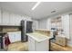 Kitchen boasts stainless steel appliances, an island, and view to backyard at 730 N Bethany Rd, Mcdonough, GA 30252