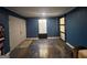 Spacious living room features sliding door, custom floor, and fresh, modern color palette at 730 N Bethany Rd, Mcdonough, GA 30252