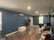 Open-concept living room with painted floor, modern mini-split, and modern entertainment setup at 730 N Bethany Rd, Mcdonough, GA 30252