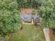 House nestled in a wooded lot, aerial view at 107 Rolling Green, Peachtree City, GA 30269