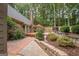 Landscaped backyard with retaining walls and a spacious deck at 107 Rolling Green, Peachtree City, GA 30269