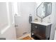 Modern bathroom with a dark vanity and hexagon mirror at 107 Rolling Green, Peachtree City, GA 30269