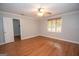 Bright bedroom with hardwood floors, ceiling fan and window at 107 Rolling Green, Peachtree City, GA 30269