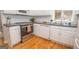 Kitchen with white cabinets, stainless steel appliances, and dark countertop at 107 Rolling Green, Peachtree City, GA 30269