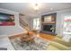 Living room with fireplace, hardwood floors, and large windows at 107 Rolling Green, Peachtree City, GA 30269