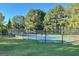 Community tennis court with surrounding fence at 107 Rolling Green, Peachtree City, GA 30269