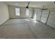 Spacious two-car garage with concrete flooring, white walls, and natural light from the windows at 2791 Riverchess Ct # 147, Atlanta, GA 30331