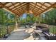 Relaxing backyard patio with wooden pergola, seating, and grill at 9435 Grande Dr, Winston, GA 30187