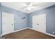 Blue bedroom with double doors and ceiling fan at 9435 Grande Dr, Winston, GA 30187