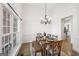 Elegant dining room with hardwood floors, chandelier and large windows at 9435 Grande Dr, Winston, GA 30187