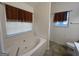 Bathroom with soaking tub and tile flooring at 190 Wynfield Dr, Covington, GA 30016