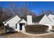 White house with dark grey roof,attached garage, and manicured shrubbery at 190 Wynfield Dr, Covington, GA 30016