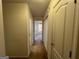 A long hallway with carpeted floors and access to bedrooms and bathroom at 190 Wynfield Dr, Covington, GA 30016