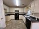 Kitchen with granite countertops and black appliances at 190 Wynfield Dr, Covington, GA 30016