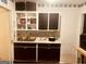 Practical kitchen with stainless steel sink, dark cabinetry, and essential appliances at 1344 Lynford Sw Dr, Atlanta, GA 30310