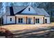 White farmhouse exterior with a front porch and landscaping at 16 Edgewater Dr, Temple, GA 30179