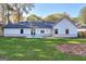 Home's rear elevation, showcasing a patio and grassy yard at 1947 Clark Dr, Tucker, GA 30084