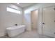 Luxurious bathroom with soaking tub, modern fixtures, and tile flooring at 1947 Clark Dr, Tucker, GA 30084