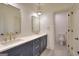 Double vanity bathroom with dark blue cabinets and gold fixtures at 1947 Clark Dr, Tucker, GA 30084