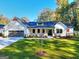 Craftsman style home with white siding, gray roof, and a landscaped lawn at 1947 Clark Dr, Tucker, GA 30084