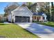 Two-car garage with dark gray doors and a concrete driveway at 1947 Clark Dr, Tucker, GA 30084