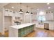 Modern kitchen with white cabinets, green island, and quartz countertops at 1947 Clark Dr, Tucker, GA 30084