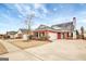 Red brick house with a white garage door and landscaping at 155 Woodgate Cir, Fayetteville, GA 30215