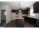 Modern kitchen with dark cabinets and granite island at 5635 Laney Dr # Ln34, Rex, GA 30273