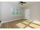 Bright bedroom with wood-look floors, ceiling fan, and multiple windows at 2036 E Camellia Dr, Decatur, GA 30032