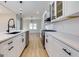 Modern kitchen featuring white cabinets, quartz countertops, and stainless steel appliances at 2036 E Camellia Dr, Decatur, GA 30032