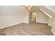 Bedroom with sloped ceilings, hardwood floors, and mirrored closet doors at 215 Glenleigh Walk, Fayetteville, GA 30214