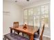 Bright dining area with wood table, bench seating, and plantation shutters at 215 Glenleigh Walk, Fayetteville, GA 30214