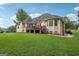 Expansive backyard featuring a deck, lush lawn, and mature trees, providing ample space for recreation and relaxation at 418 Branch Forest Way, Stockbridge, GA 30281