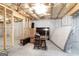 Unfinished basement with partial framing and storage items at 418 Branch Forest Way, Stockbridge, GA 30281