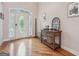 Inviting foyer with hardwood floors, decorative glass door, and stylish console table enhances the home's entry at 418 Branch Forest Way, Stockbridge, GA 30281