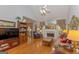 Spacious living room featuring a fireplace, hardwood floors, and ample natural light at 245 Woodstream Way, Fayetteville, GA 30214