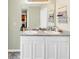 Double vanity bathroom with a large mirror and white cabinets at 11945 Lovejoy Crossing Way, Hampton, GA 30228