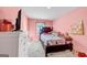 Bedroom with a bed and pink walls at 11945 Lovejoy Crossing Way, Hampton, GA 30228