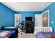 Blue bedroom with two beds and a gaming chair at 11945 Lovejoy Crossing Way, Hampton, GA 30228