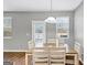 Bright dining area with wood table and chairs, near sliding door at 11945 Lovejoy Crossing Way, Hampton, GA 30228