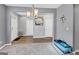 Bright dining area with gray walls, carpet flooring, and a large artwork at 11945 Lovejoy Crossing Way, Hampton, GA 30228