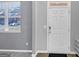 Front entry with white door, gray walls, and wood-look flooring at 11945 Lovejoy Crossing Way, Hampton, GA 30228