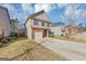 Two-story house with brick and beige siding, a two-car garage, and a driveway at 11945 Lovejoy Crossing Way, Hampton, GA 30228