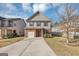 Two-story house with brick and beige siding, a two-car garage, and a landscaped front yard at 11945 Lovejoy Crossing Way, Hampton, GA 30228
