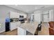 Modern kitchen with white cabinets, granite island, and stainless steel appliances at 11945 Lovejoy Crossing Way, Hampton, GA 30228